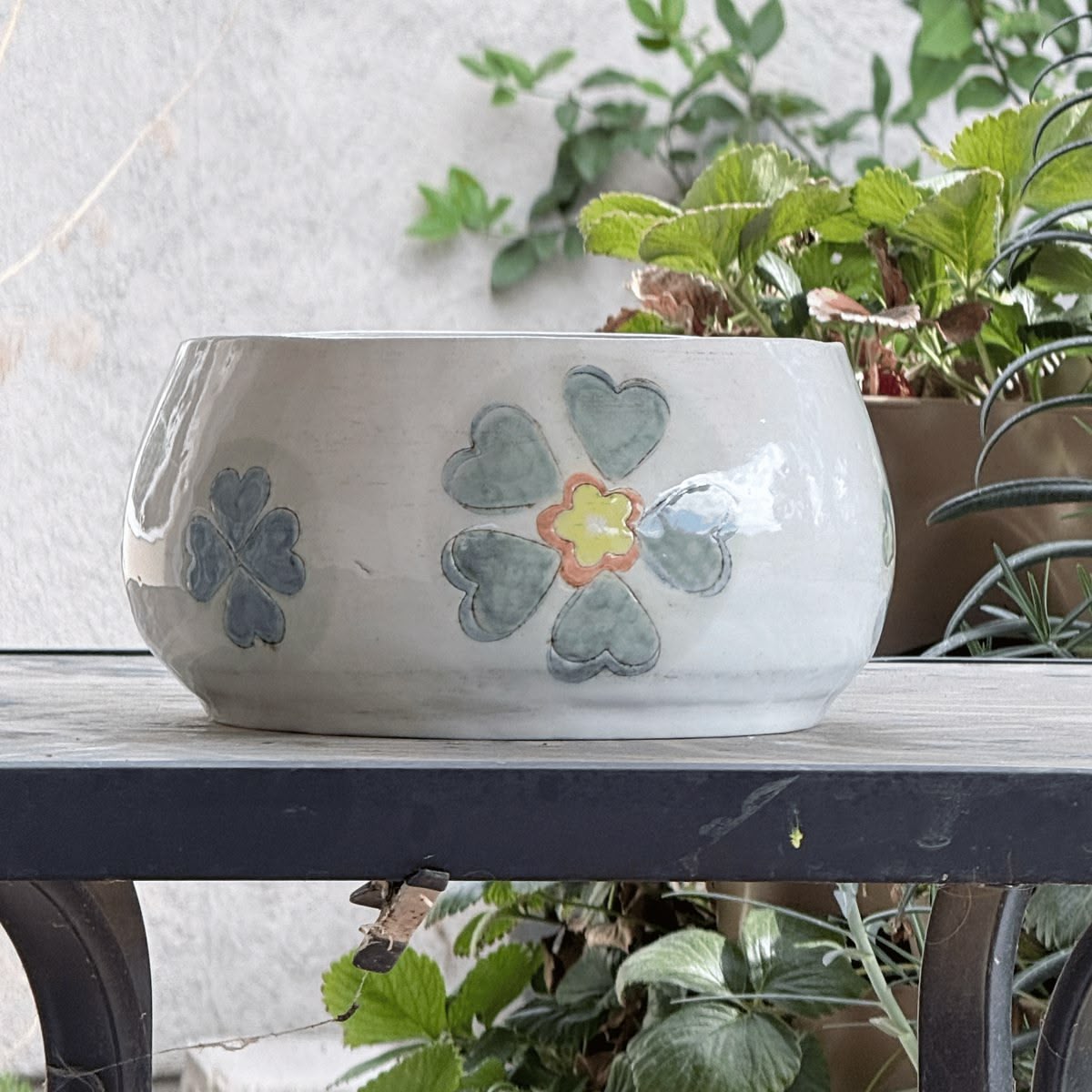 Before: hand-painted ceramic bowl on a garden bench